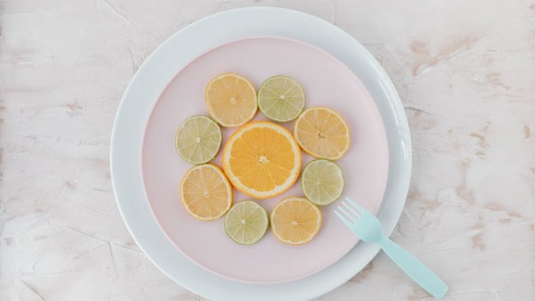 Top view of citrus slices on ceramic plates, showcasing lime and orange artistry.